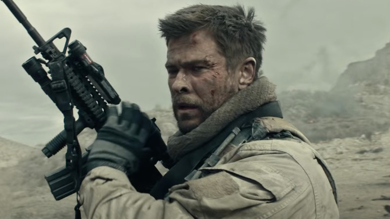 Chris Hemsworth holding rifle