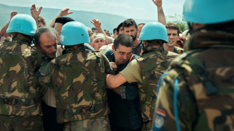 Nihad trying to push past UN workers in "Quo Vadis, Aida?"