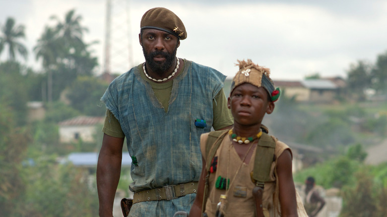 Commandant standing near Agu in Beasts of No Nation
