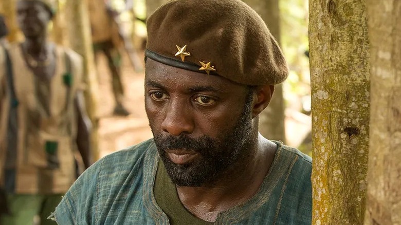 Commandant standing near a tree sweating in Beasts of No Nation