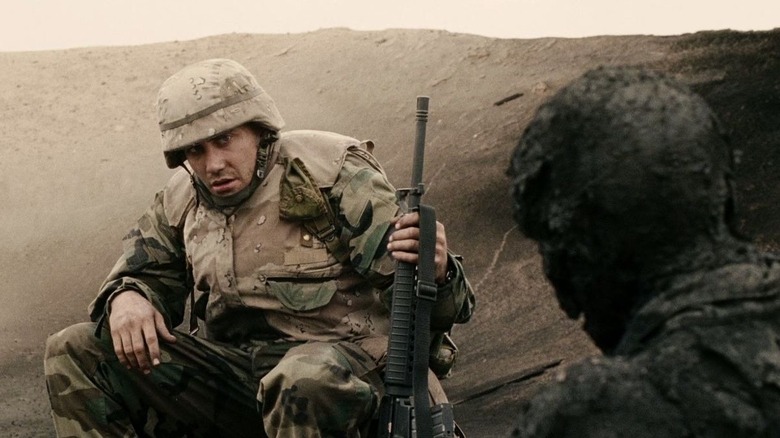 Swoff holding his gun talking to another soldier in Jarhead