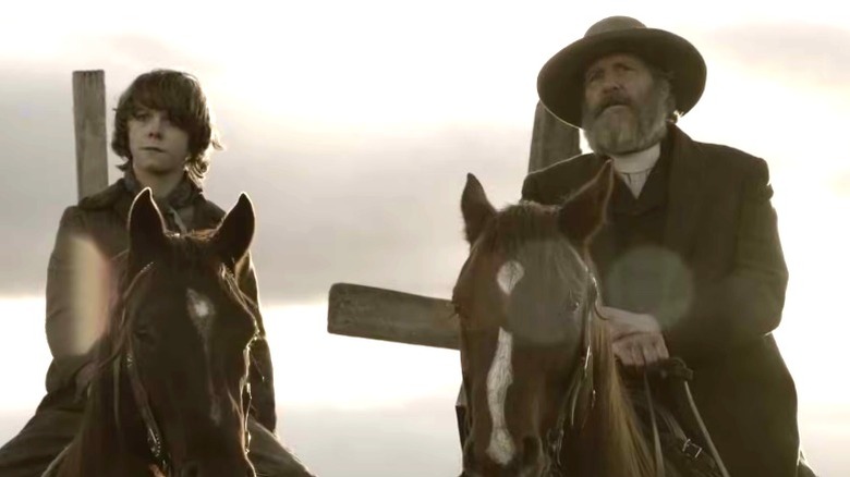Frank Griffin and a young boy on horseback on Godless (2017)