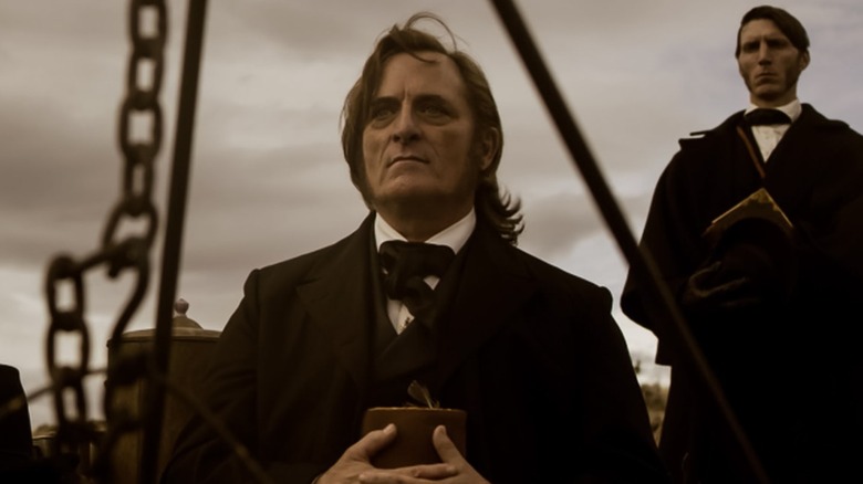 Brigham Young holding a bible in "American Primeval" (2025)