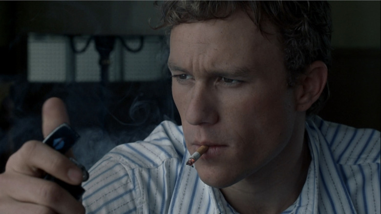 Ennis lights a cigarette