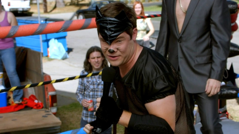 Adam in cat costume holds mic