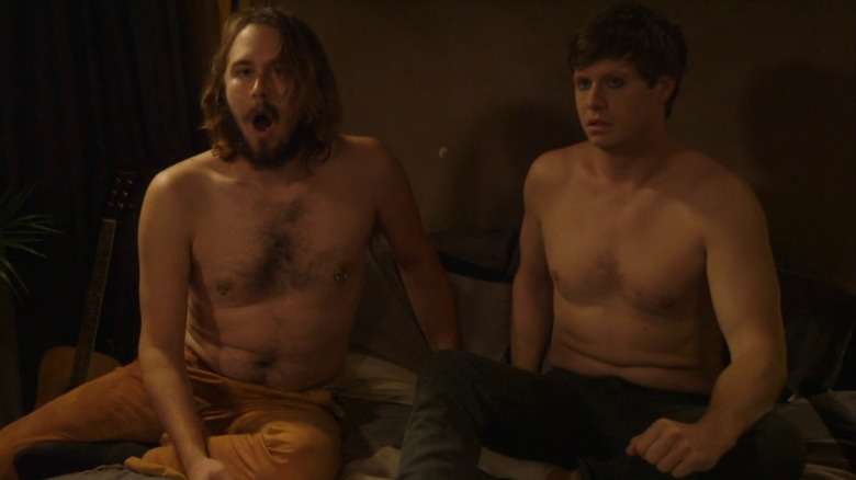 Surprised Karl and concerned Anders sit in bed