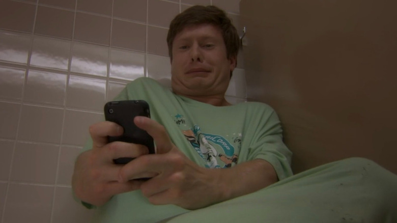 Terrified Anders looks at phone