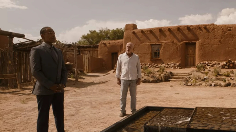 Gus and Mike talking by a fountain