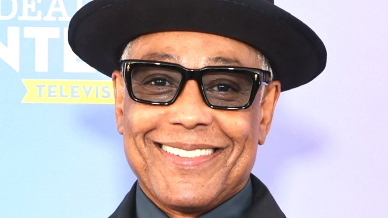 Giancarlo Esposito smiling with a hat and glasses