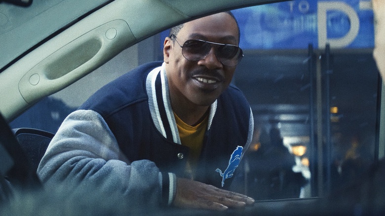 Axel Foley leaning in a car