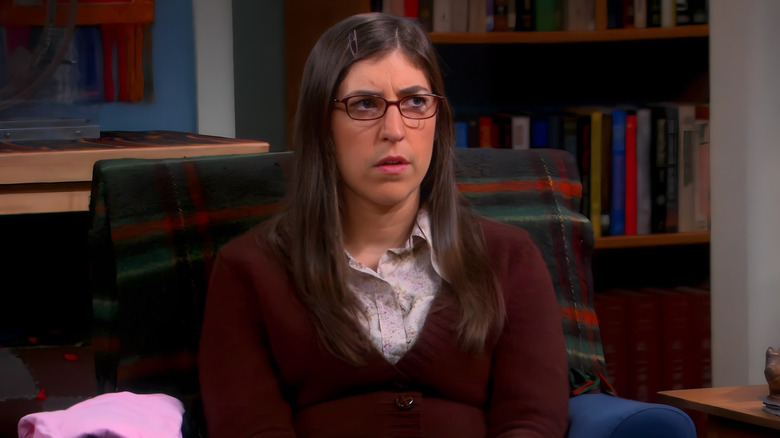 Amy looking confused in an armchair
