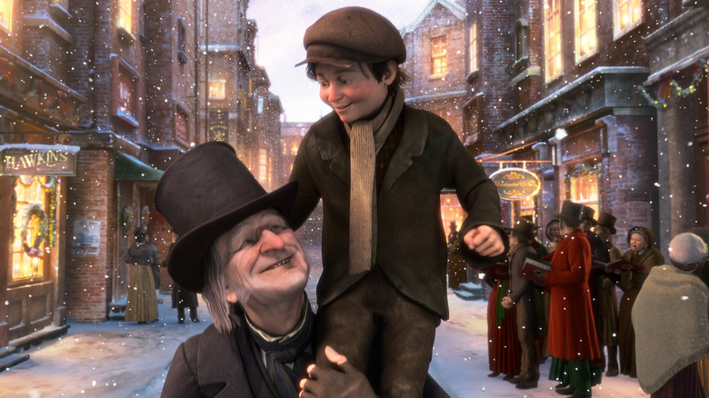 Ebenezer Scrooge holding Tiny Tim on his shoulder in A Christmas Carol (2009)