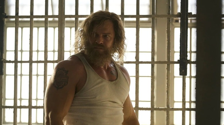John Miller looking around his prison cell in Motor City (2026)