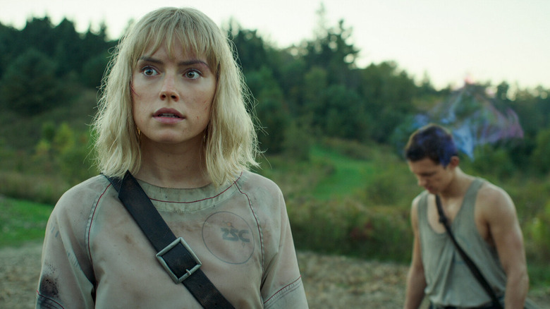 Viola Eade standing in front of Todd Hewitt in "Chaos Walking" (2021)