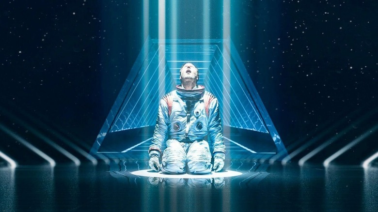 Brian Harper falling to his knees in space in "Moonfall" (2022)