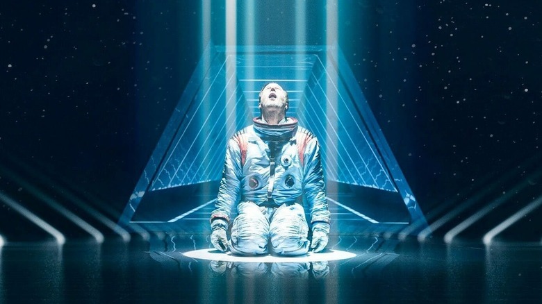 Brian Harper falling to his knees in space in "Moonfall" (2022)