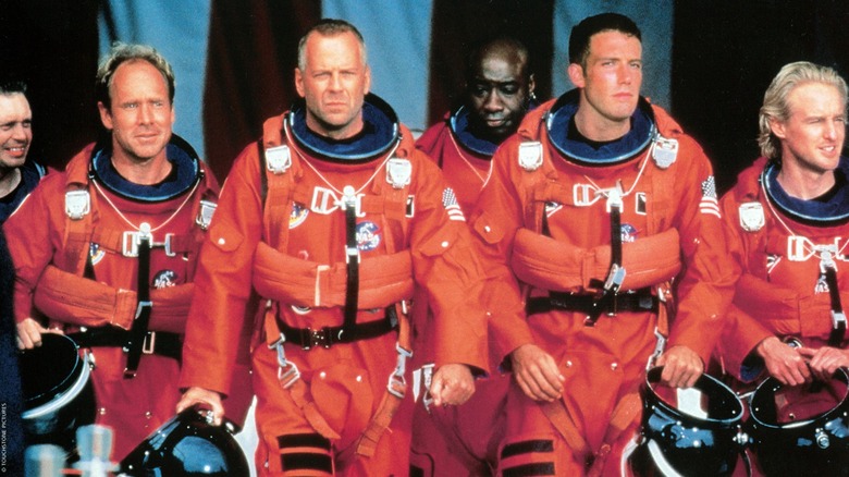 A group of drill workers in spacesuits walking together in "Armageddon"