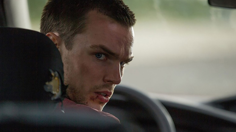 Casey looking back in the driver's seat in "Collide" (2017)
