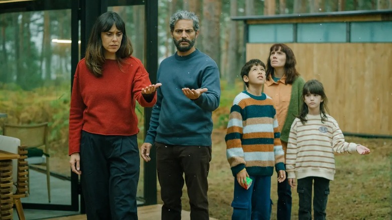 Mara and Luis hold out their hands as ash begins to fall in "Firebreak" (2026)