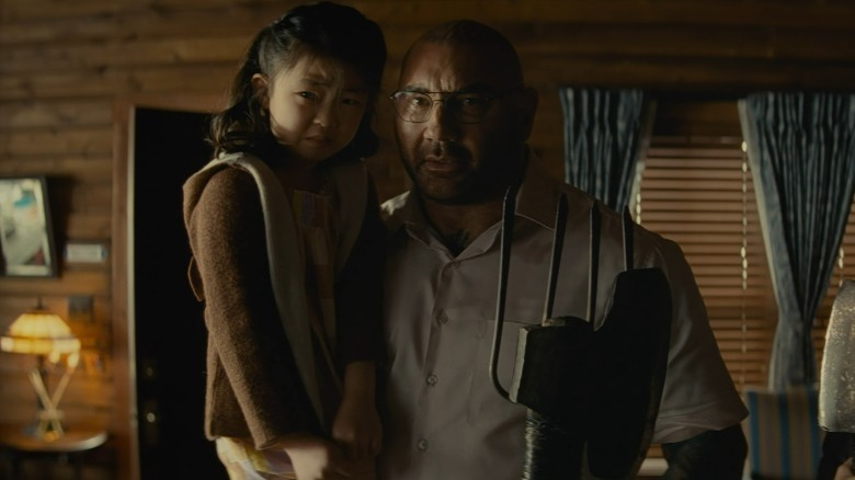 Leonard holding Wen and his weapon
