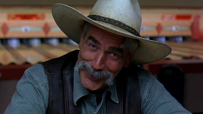 The Stranger smiles at the camera