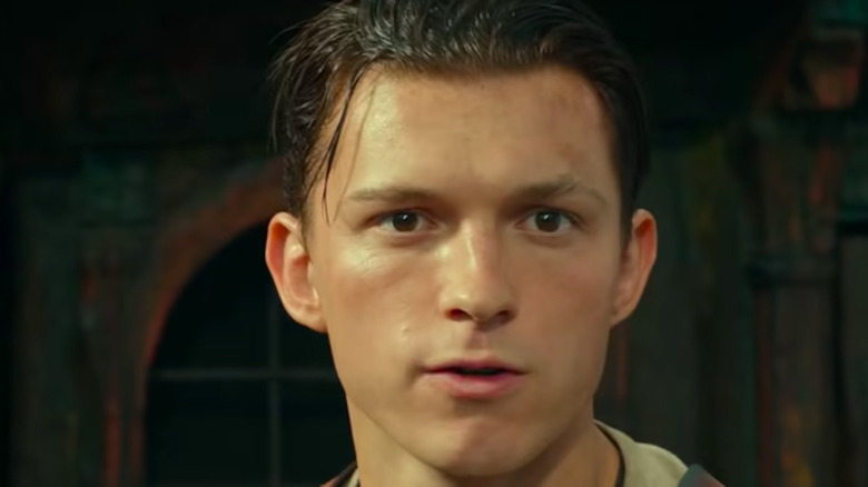 Tom Holland as Nathan Drake looking determined