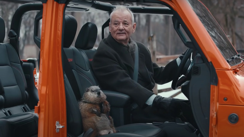 Bill Murray with a groundhog in his Jeep