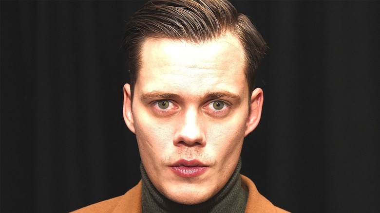 Bill Skarsgård poses at event 