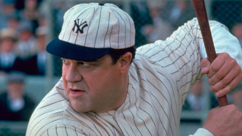 John Goodman as Babe Ruth, holding baseball bat