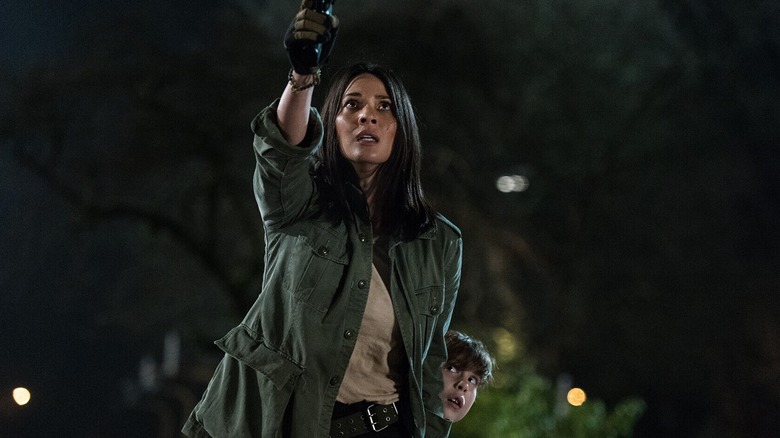 Dr. Casey Brackett protects young Rory McKenna in The Predator