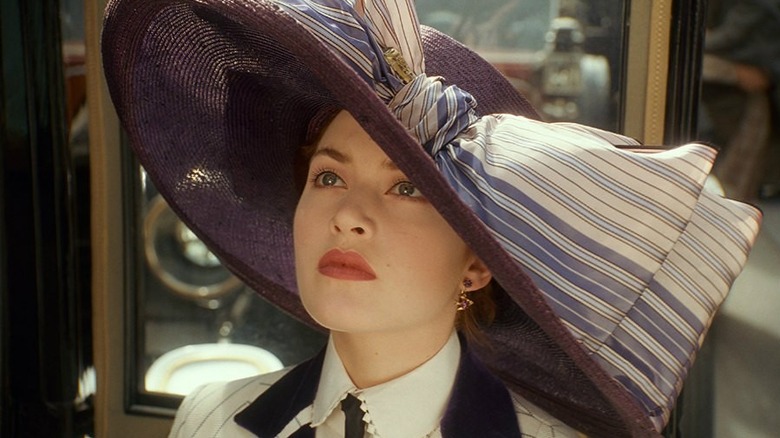 Rose looks up under big hat