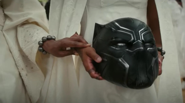 Hands holding the Black Panther mask