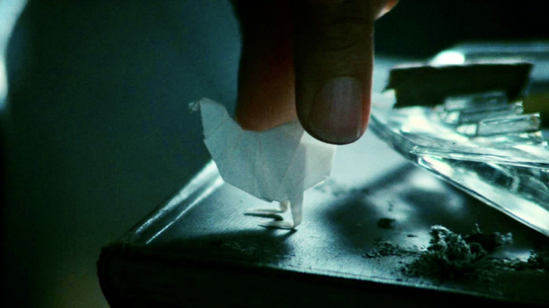 Fingers place origami bird