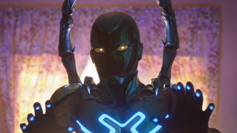 Blue Beetle holding his hands up