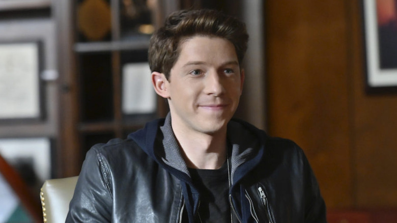 Joe smiles in an office