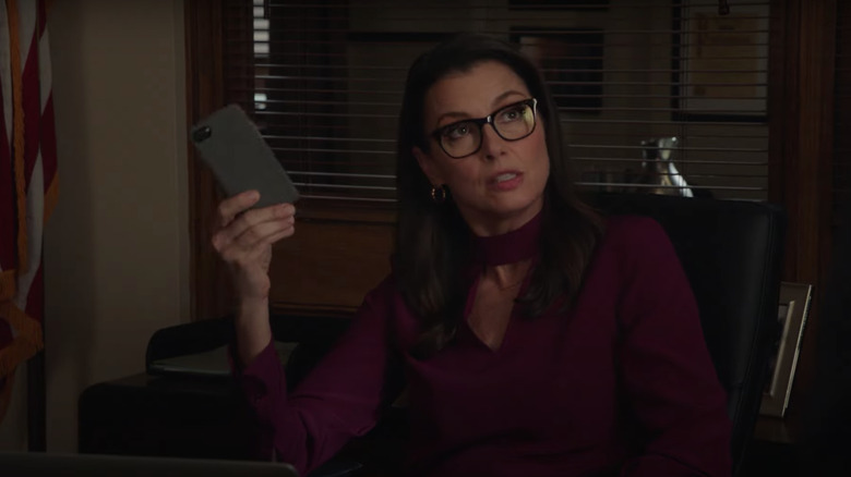 Bridget Moynahan holding iPhone