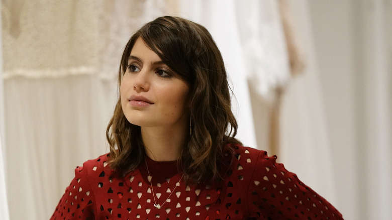 Nicky Reagan stands in white room in "Blue Bloods"