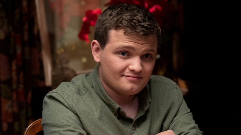 Sean Reagan smirking at the dinner table in "Blue Bloods"