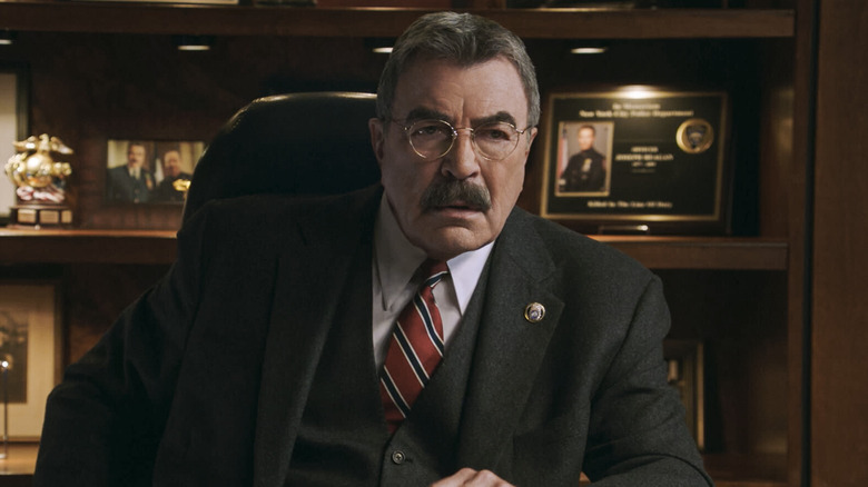 Frank Reagan sitting at his desk