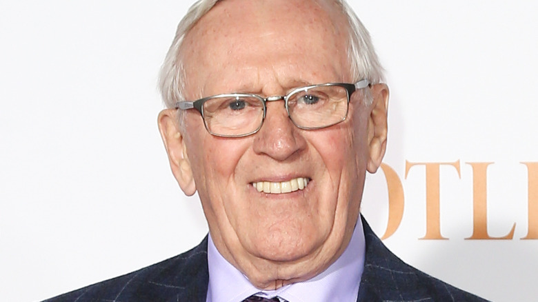 Len Cariou smiling and wearing glasses