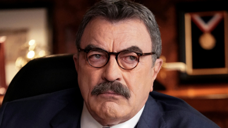 Tom Selleck glares under glasses