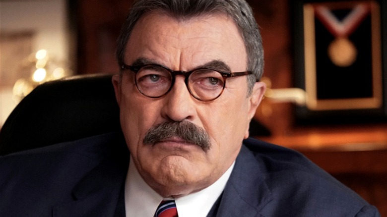 Tom Selleck glares under glasses