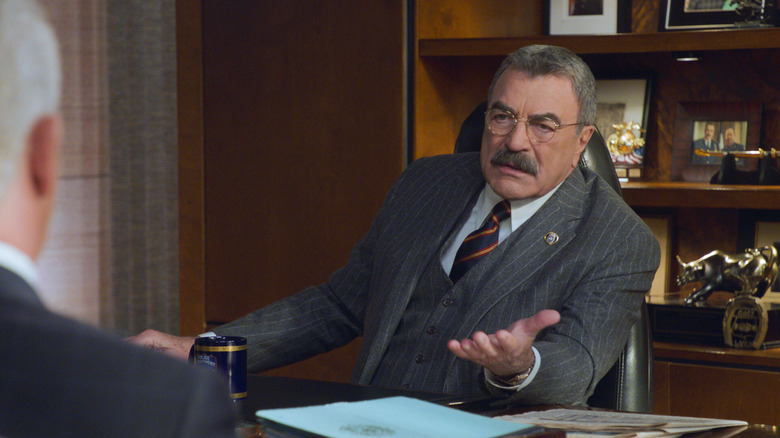 Frank Reagan talking at his desk