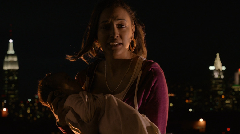 Noni holds her baby