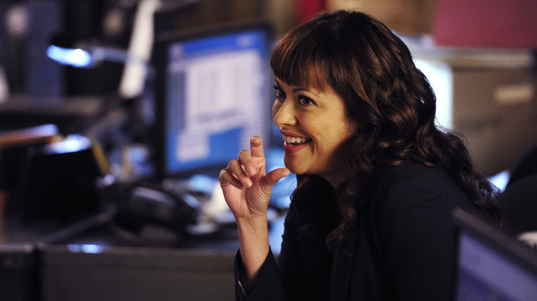 Baez grinning in "Blue Bloods"