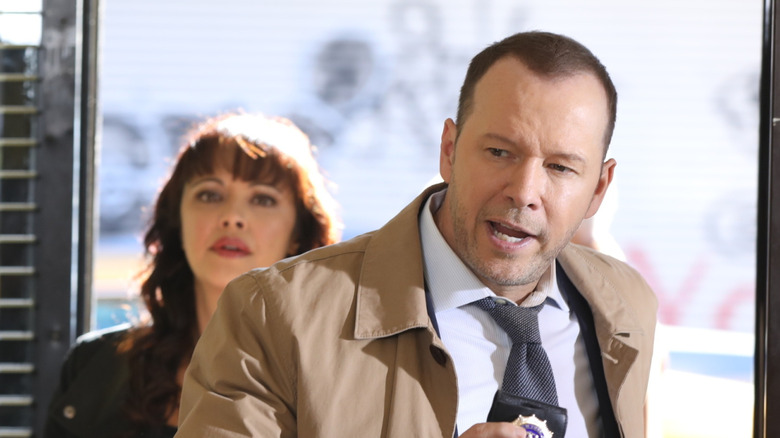 Danny and Maria burst into a building in "Blue Bloods"