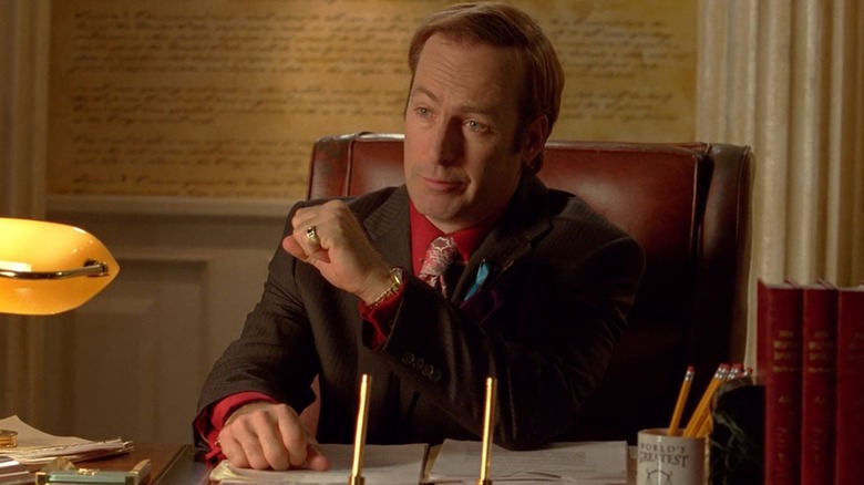 Saul Goodman sits at his desk