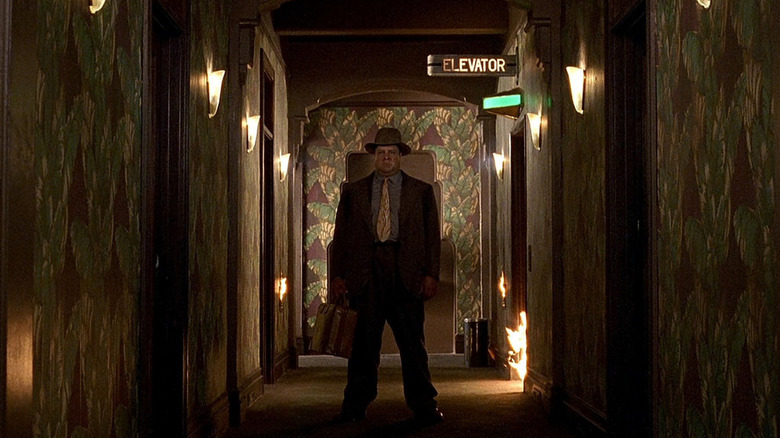 Karl Mundt standing in flaming hotel