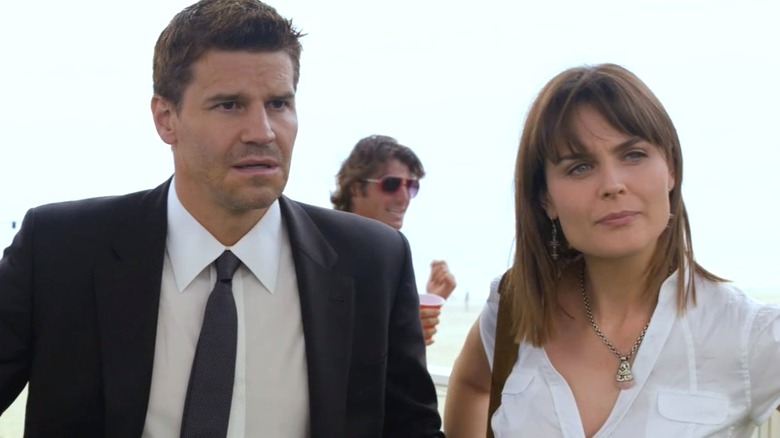 Bones and Booth standing on the boardwalk