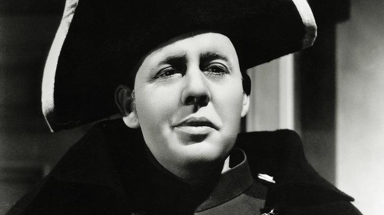 Inspector Javert listens intently in 'Les Miserables' 1935